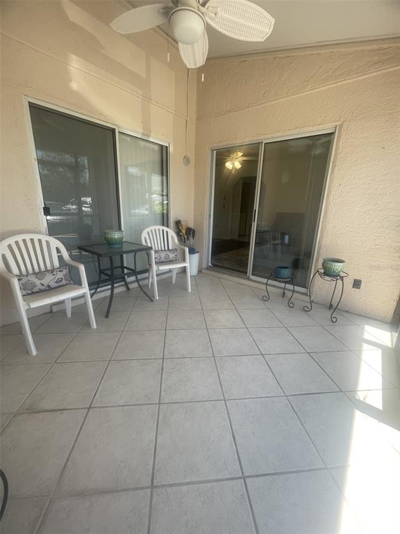 25068 Harbor View Road, Unit 3D Punta Gorda, FL 33980 - Photo 7 of 24 a outdoor space with lots of white furniture and a glass door