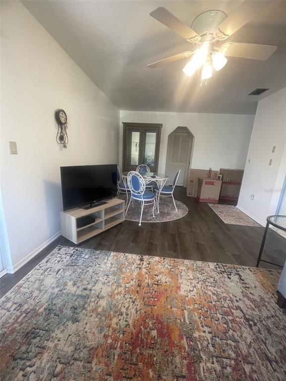 25068 Harbor View Road, Unit 3D Punta Gorda, FL 33980 - Photo 9 of 24 a living room with furniture a flat screen tv and a fireplace