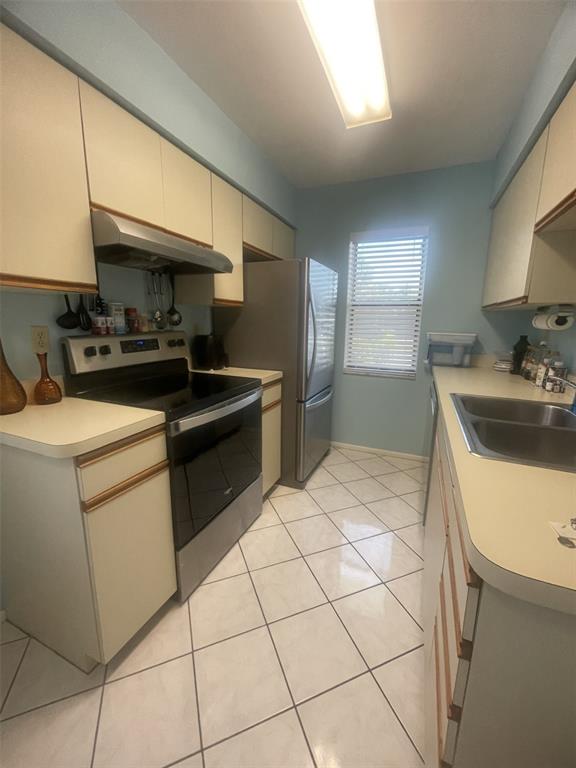 25068 Harbor View Road, Unit 3D Punta Gorda, FL 33980 - Photo 10 of 24 a kitchen that has a sink and a stove in it