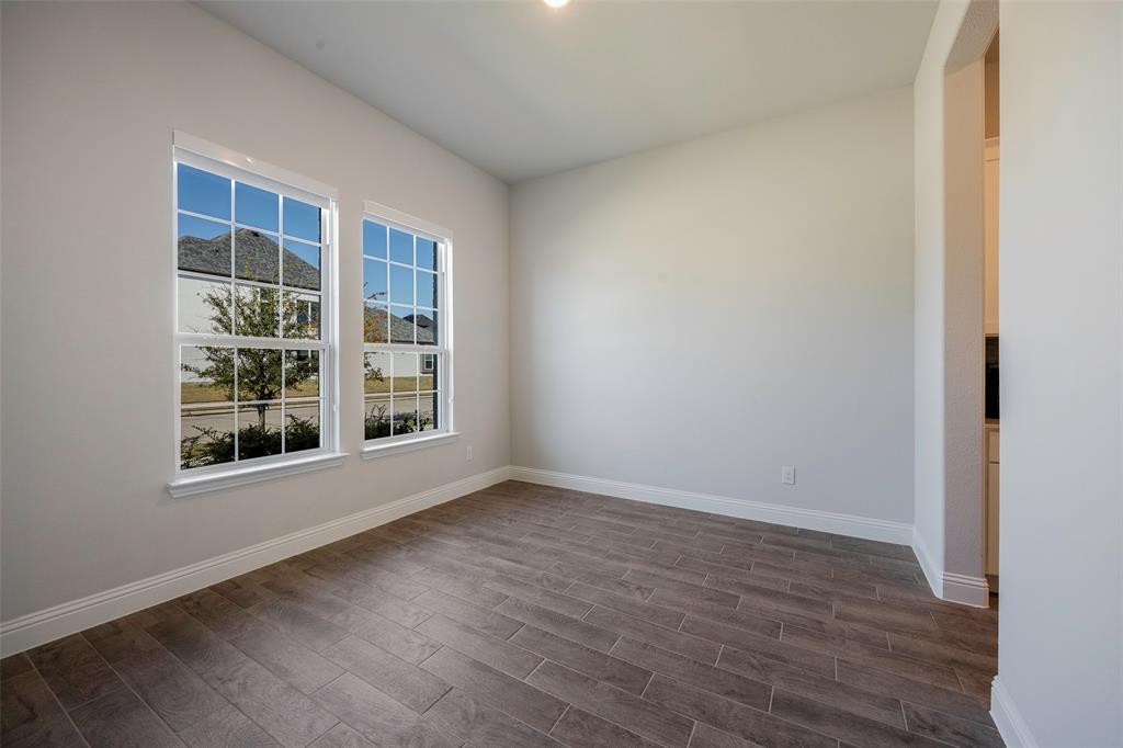 1617 Hitching Post Road Weston, TX 75009 - Photo 13 of 30 an empty room with wooden floor and windows