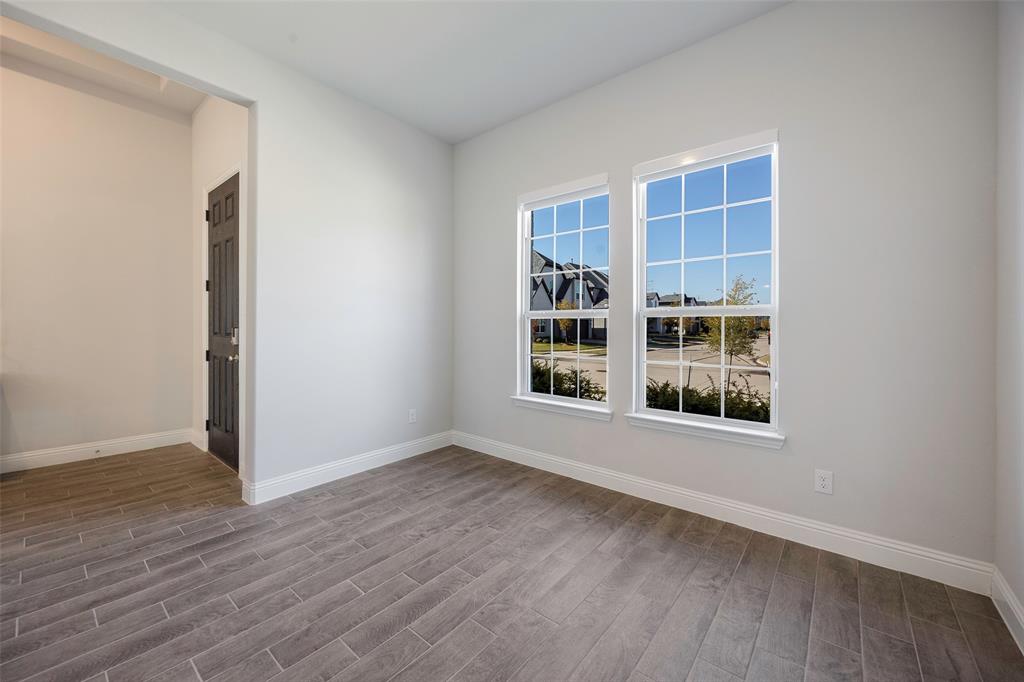 1617 Hitching Post Road Weston, TX 75009 - Photo 14 of 30 an empty room with wooden floor and windows