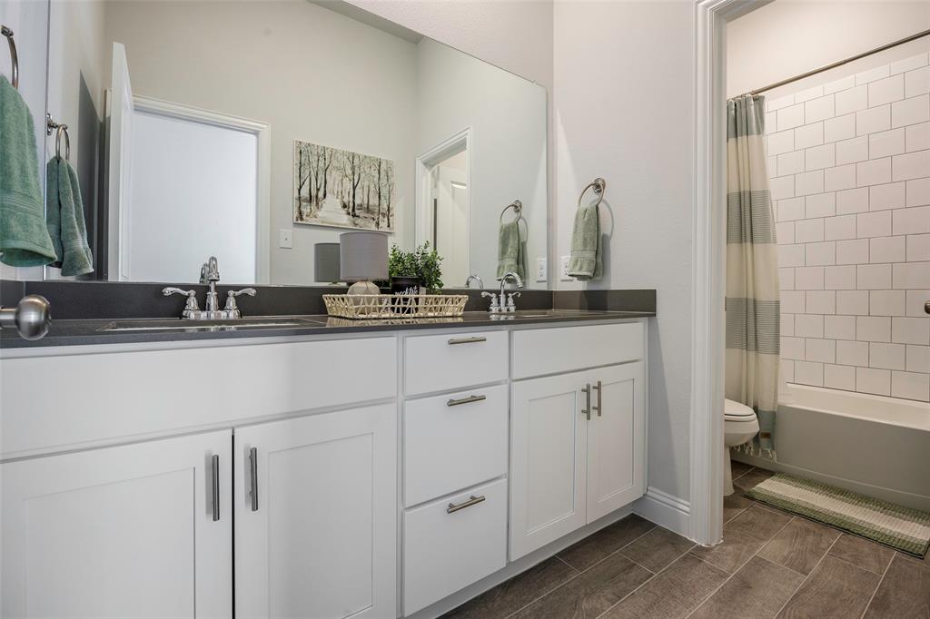 1617 Hitching Post Road Weston, TX 75009 - Photo 22 of 30 a bathroom with a double vanity sink and a mirror
