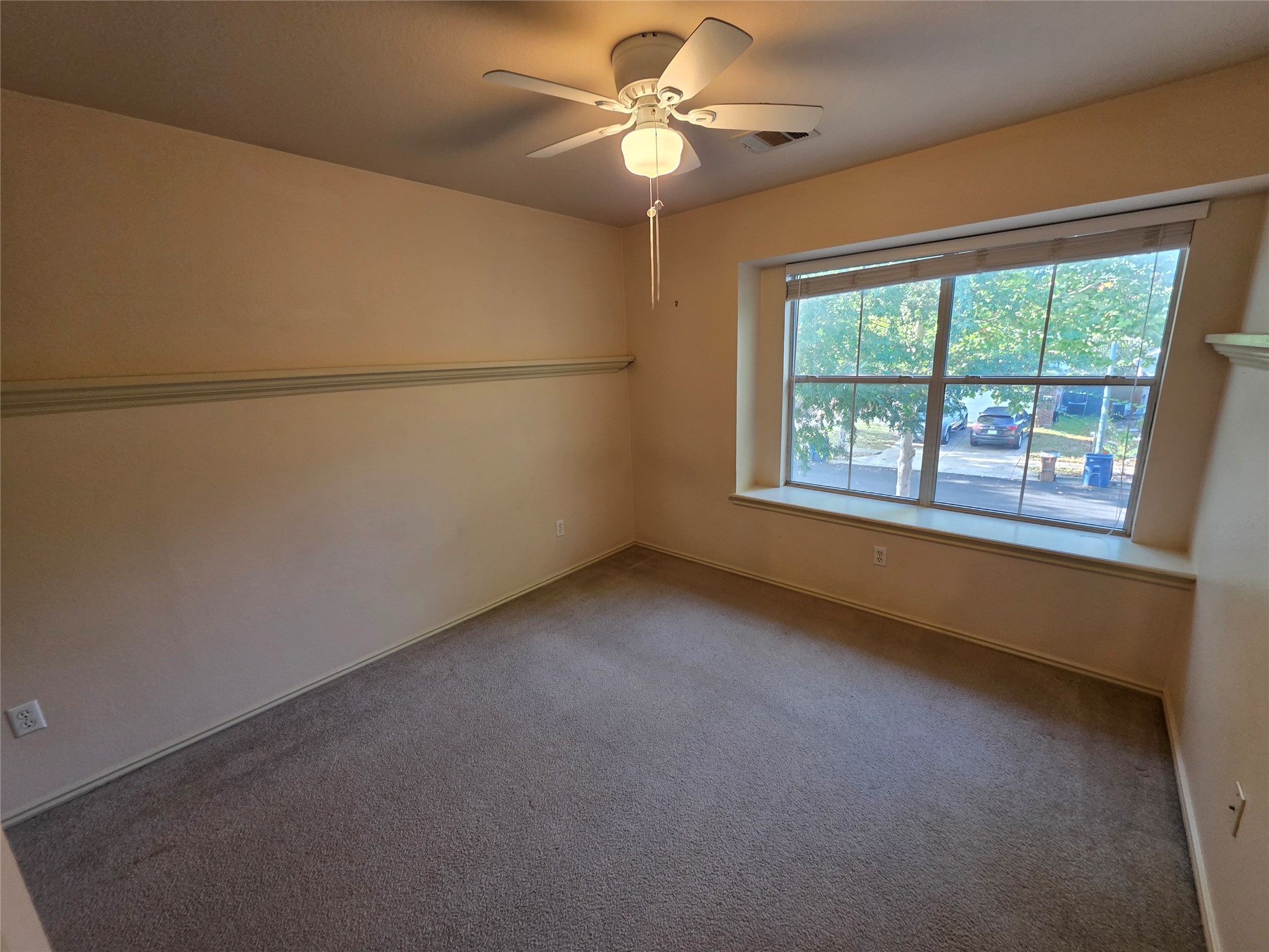 2210 Wilma Rudolph Road Austin, TX 78748 - Photo 14 of 20 Carpeted flooring and a deep window sill define this comfortable bedroom space.