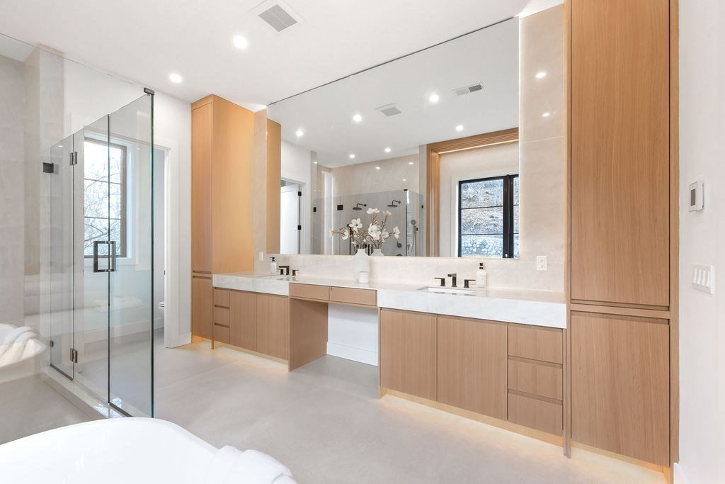 28 Cottonwood Road Newton, MA 02459 - Photo 16 of 25 a bathroom with a tub sink mirror and shower