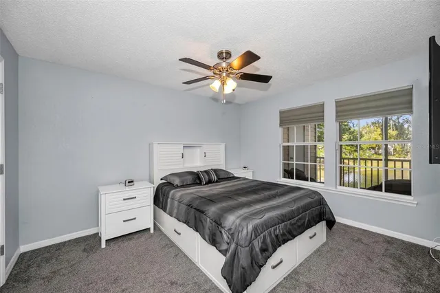 a bedroom with a bed and a large window