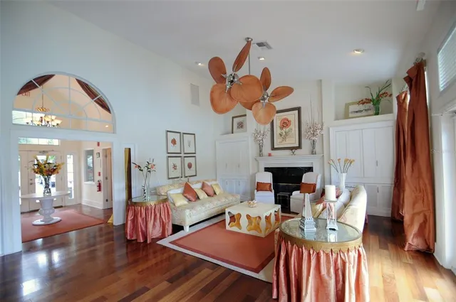 a living room with furniture a fireplace and a flat screen tv