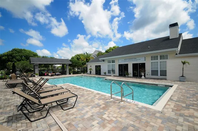 a view of a house with backyard and sitting area