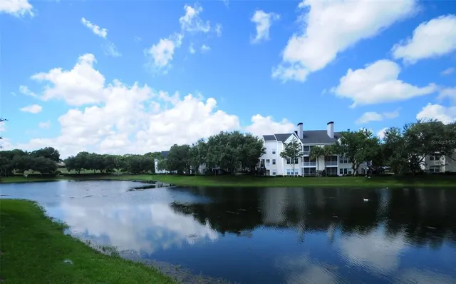 a view of a lake with houses in the back