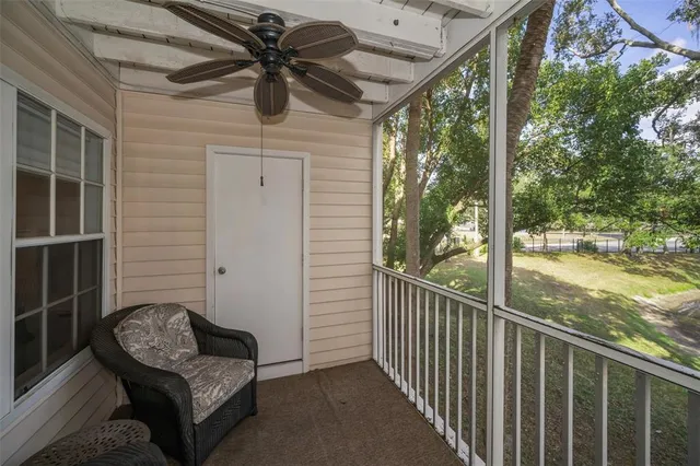 a view of a porch with furniture and a yard