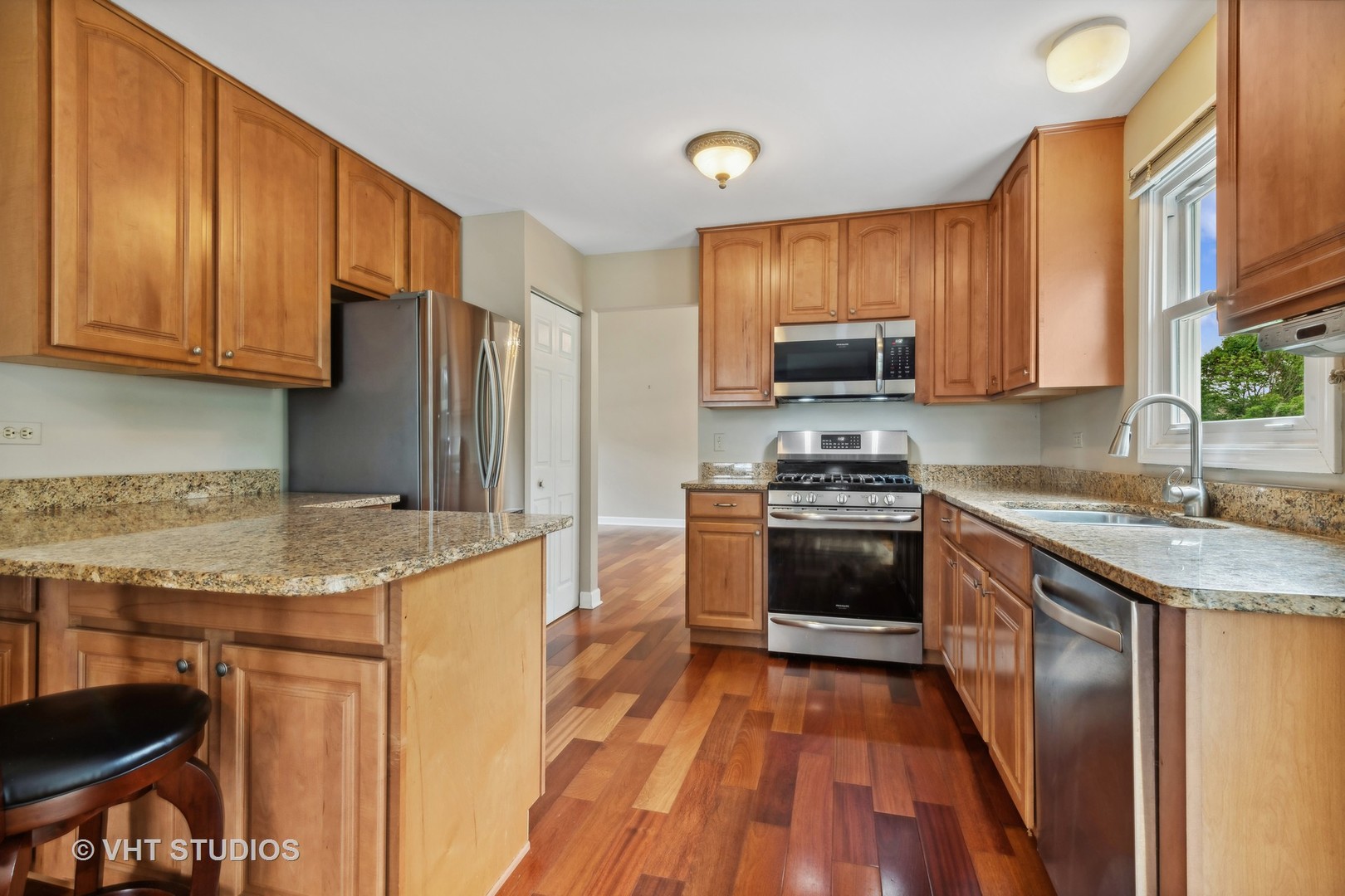 808 Burr Oak Circle Cary, IL 60013 - Photo 5 of 20 a kitchen with granite countertop a stove and a sink