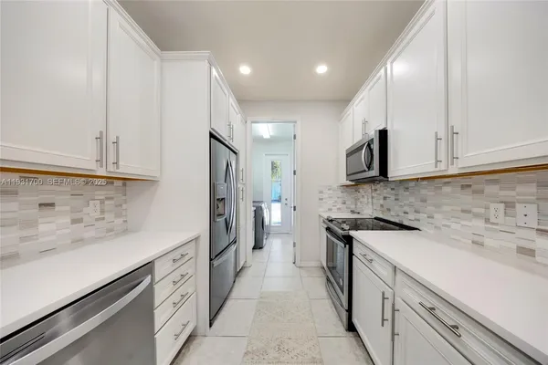 a kitchen with a sink stove and cabinets