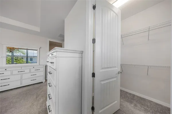 a bathroom with a granite countertop sink a large mirror and shower