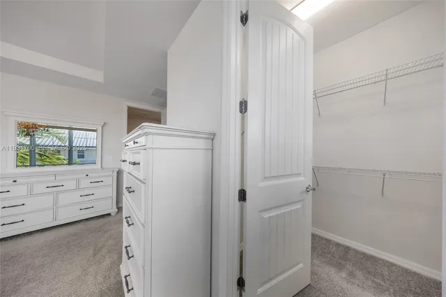 a bathroom with a granite countertop sink a large mirror and shower