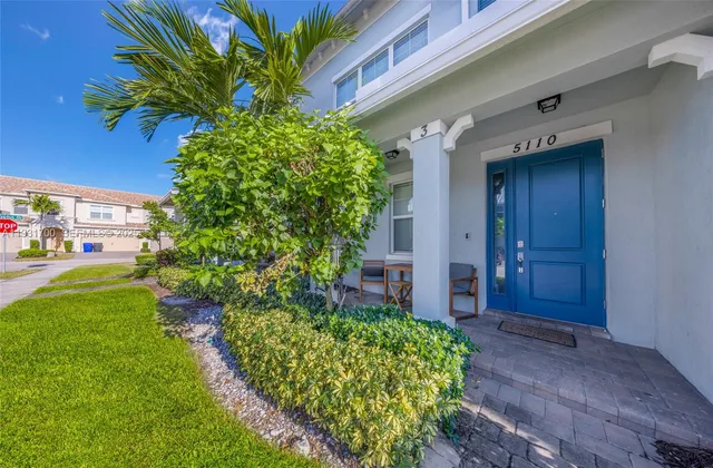 a view of a hallway with a dining room and wooden floor