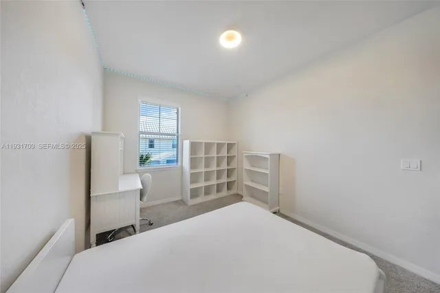 a bedroom with a bed and a chair