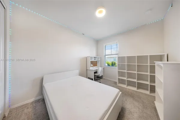 a bathroom with a granite countertop sink a mirror a toilet and shower