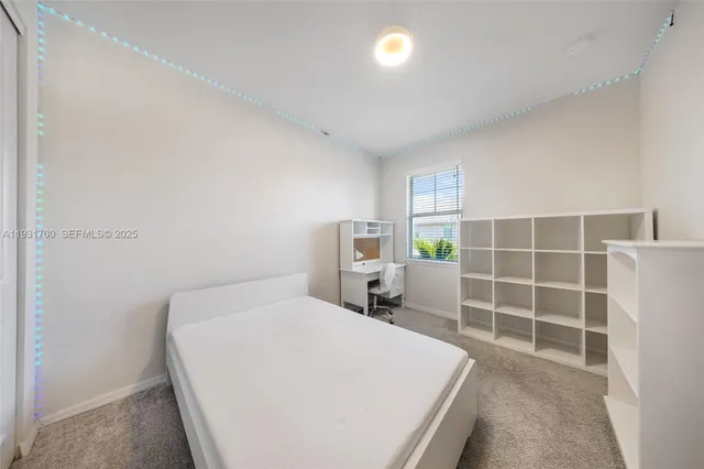 a bathroom with a granite countertop sink a mirror a toilet and shower
