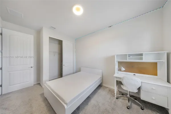 an empty room with chandelier fan