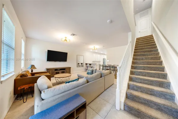 a living room with furniture and a large window