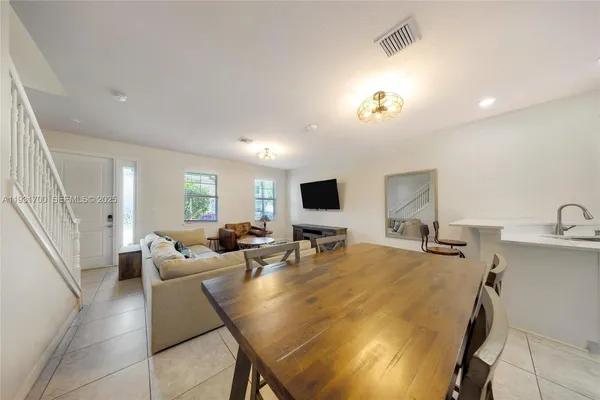 a view of kitchen with dining area and chandelier