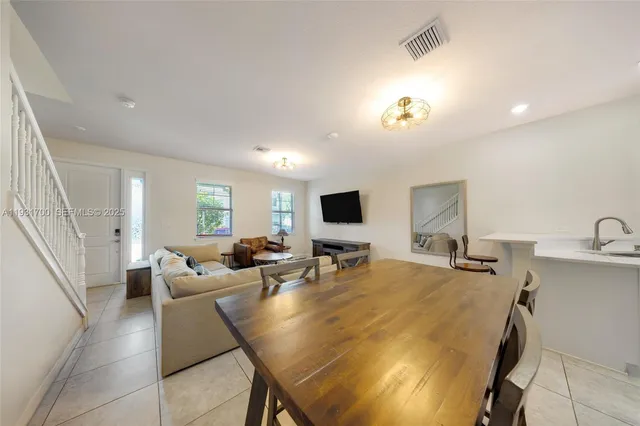 a view of kitchen with dining area and chandelier