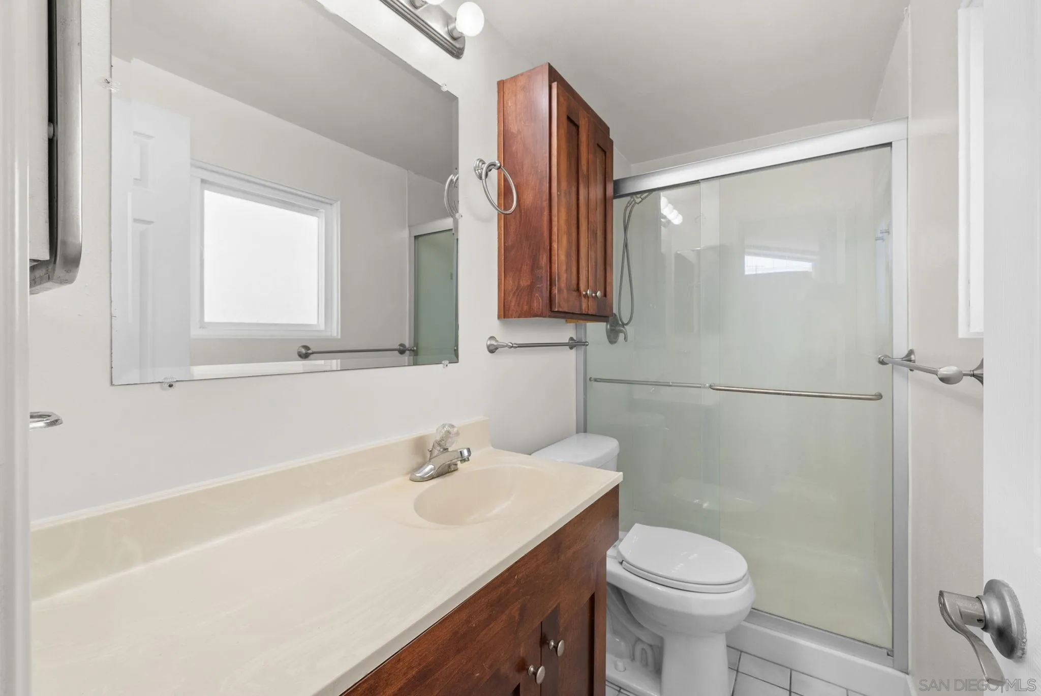 9101 Ronda Avenue San Diego, CA 92123 - Photo 11 of 20 a bathroom with a sink toilet and shower