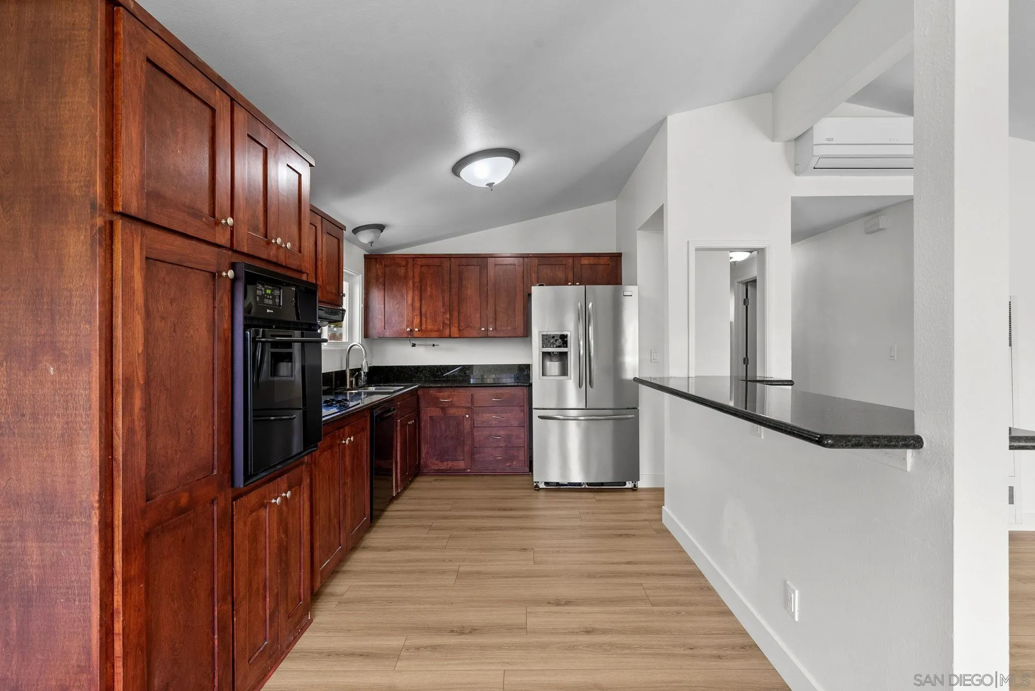 9101 Ronda Avenue San Diego, CA 92123 - Photo 7 of 20 a kitchen with stainless steel appliances granite countertop a refrigerator and a wooden floors