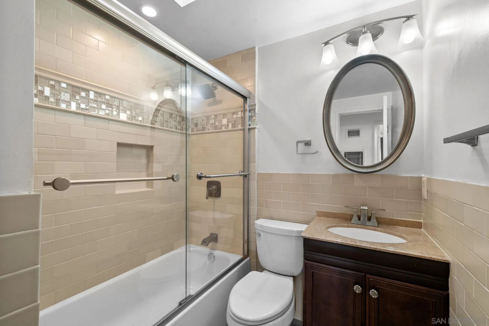 9101 Ronda Avenue San Diego, CA 92123 - Photo 9 of 20 a bathroom with a sink a toilet and a mirror