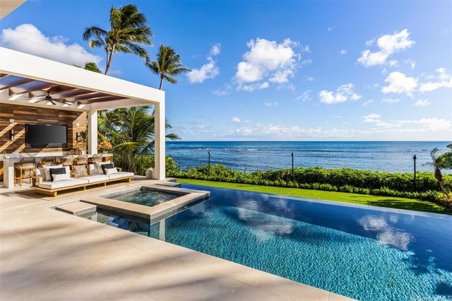 a building outdoor space with patio furniture and potted plants