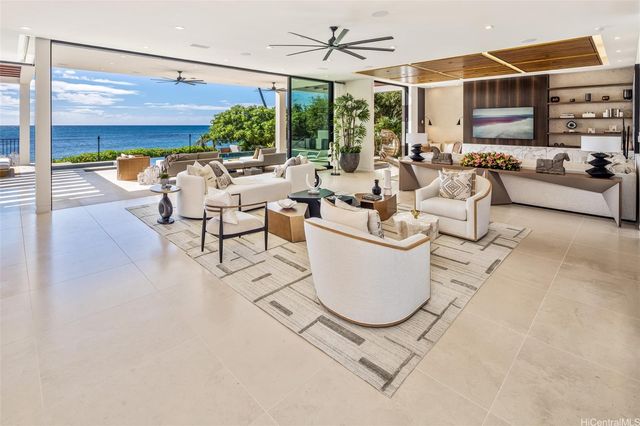 a living room with patio furniture and a floor to ceiling window