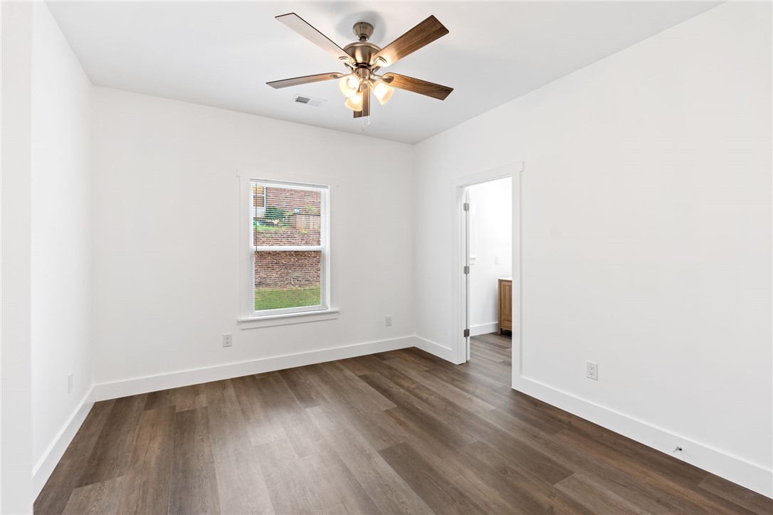 914 Smith Grove Road Easley, SC 29640 - Photo 22 of 37 A well-lit bedroom features durable plank flooring and a ceiling fan for comfort.