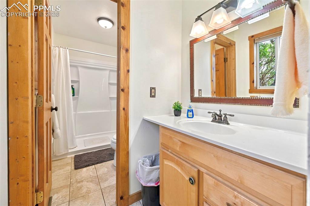 18560 Chelton Road Ramah, CO 80832 - Photo 14 of 34 a bathroom with a sink a toilet and shower
