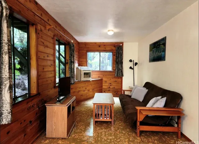 a outdoor living space with furniture and a flat screen tv