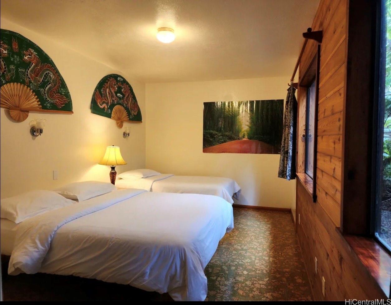 11-3832 2nd Street Volcano, HI 96785 - Photo 20 of 25 a bedroom with a bed and a flat tv screen on dresser
