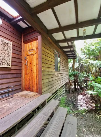 a wooden bench sitting in front of a building