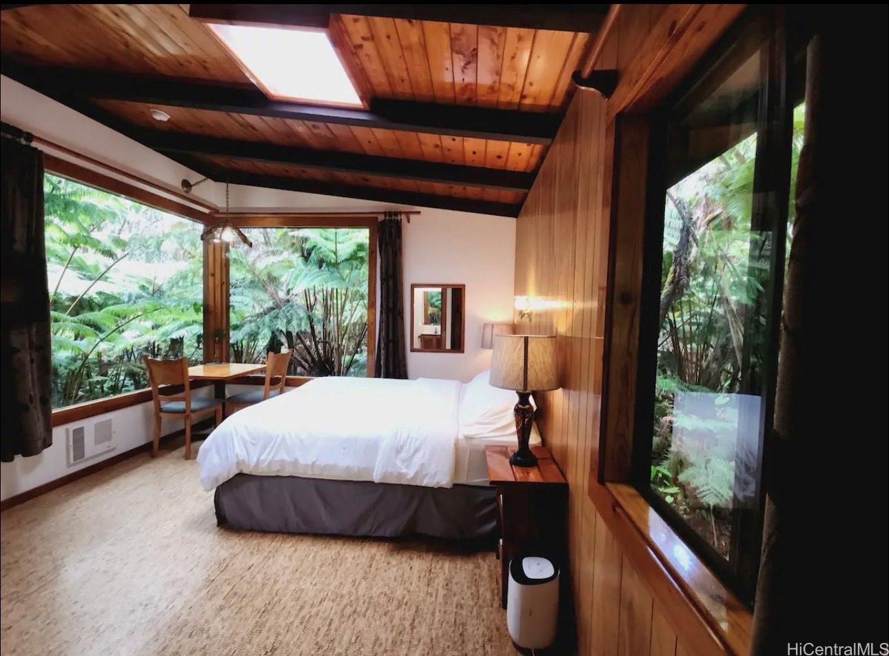 11-3832 2nd Street Volcano, HI 96785 - Photo 9 of 25 a bed room with a bed and a large window