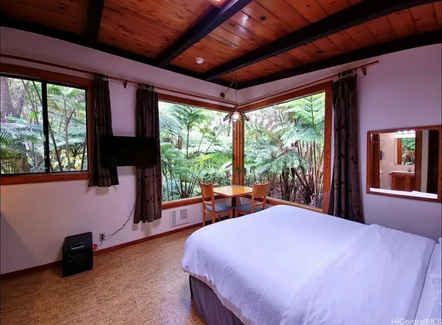 a bed room with a bed and a large window