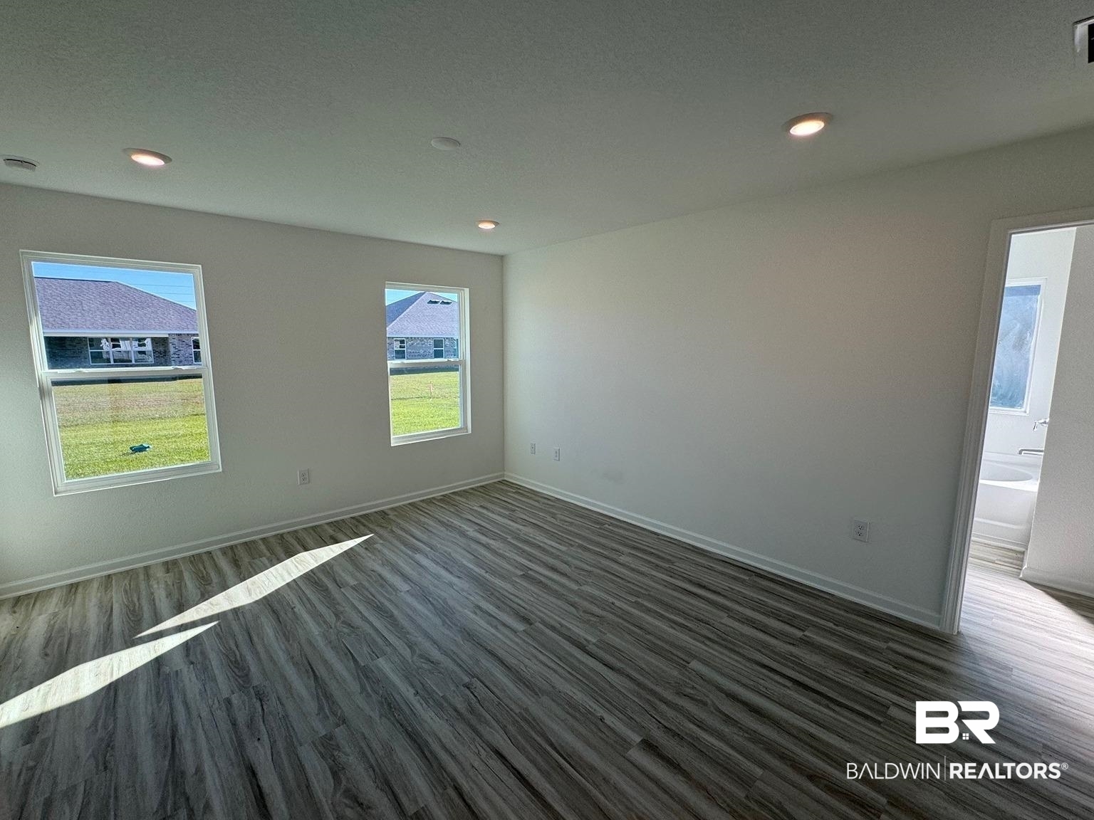 24385 Ringneck Loop Elberta, AL 36530 - Photo 12 of 33 Spare room with a textured ceiling and dark wood-type flooring