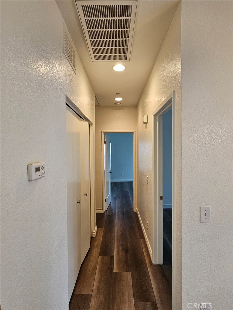 7331 Shelby Place, Unit 121 Rancho Cucamonga, CA 91739 - Photo 11 of 20 a view of a hallway with wooden floor and staircase