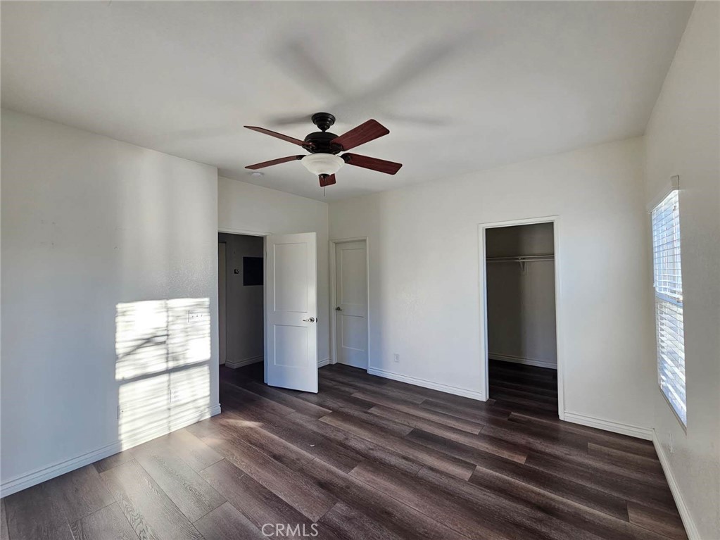7331 Shelby Place, Unit 121 Rancho Cucamonga, CA 91739 - Photo 13 of 20 a view of an empty room with wooden floor and a window
