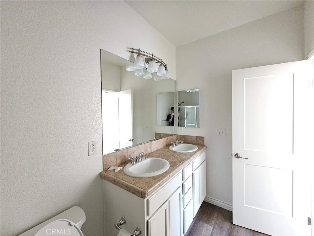 7331 Shelby Place, Unit 121 Rancho Cucamonga, CA 91739 - Photo 15 of 20 a bathroom with a sink toilet and mirror