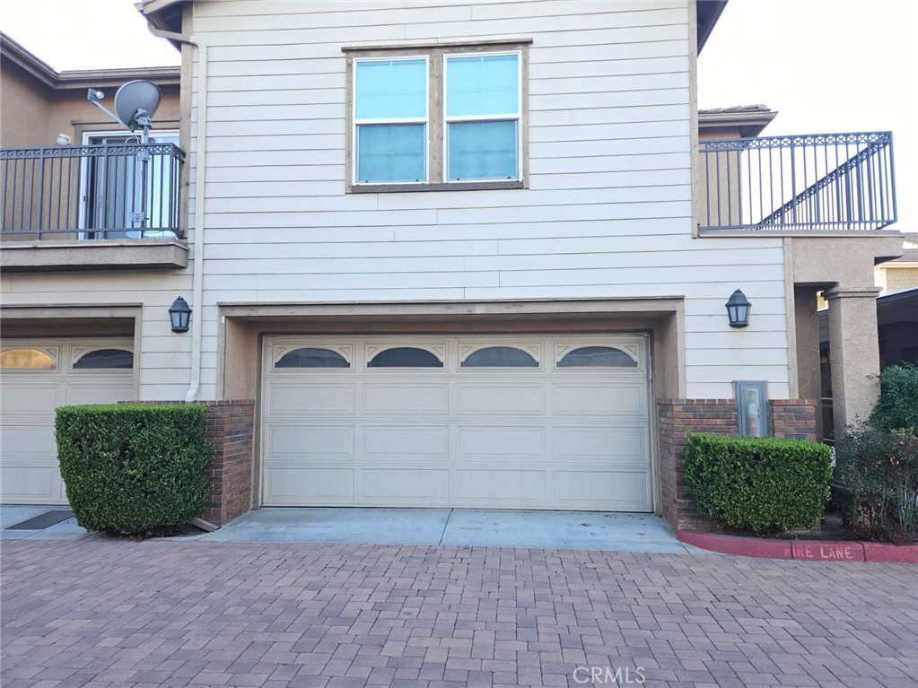7331 Shelby Place, Unit 121 Rancho Cucamonga, CA 91739 - Photo 18 of 20 a front view of a house with a yard and garage
