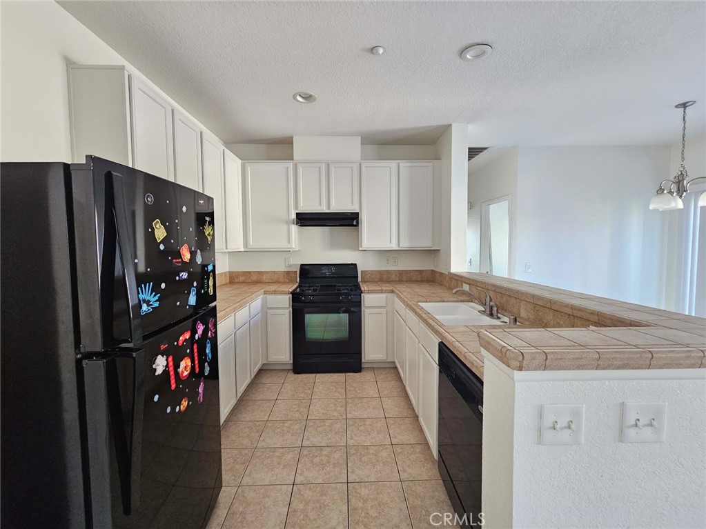 7331 Shelby Place, Unit 121 Rancho Cucamonga, CA 91739 - Photo 8 of 20 a kitchen with stainless steel appliances granite countertop a refrigerator stove and sink