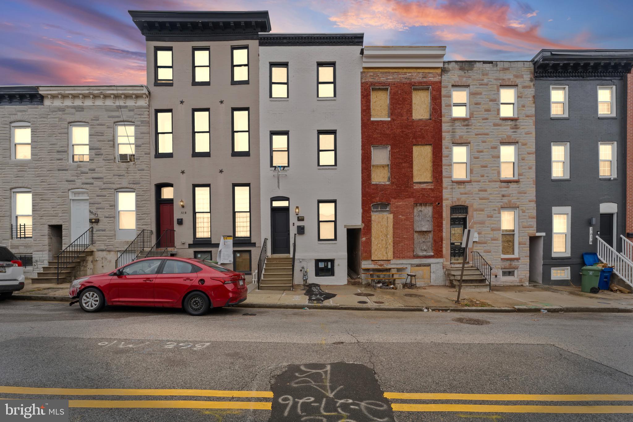 1612 East Chase Street Baltimore, MD 21213 - Photo 2 of 48 a cars parked in front of a building