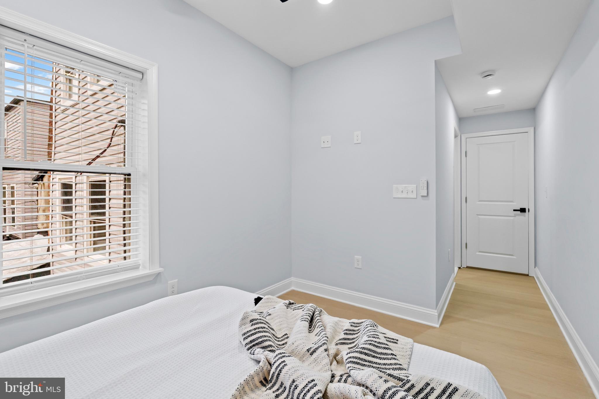 1612 East Chase Street Baltimore, MD 21213 - Photo 25 of 48 a bedroom with a bed and a window with chair
