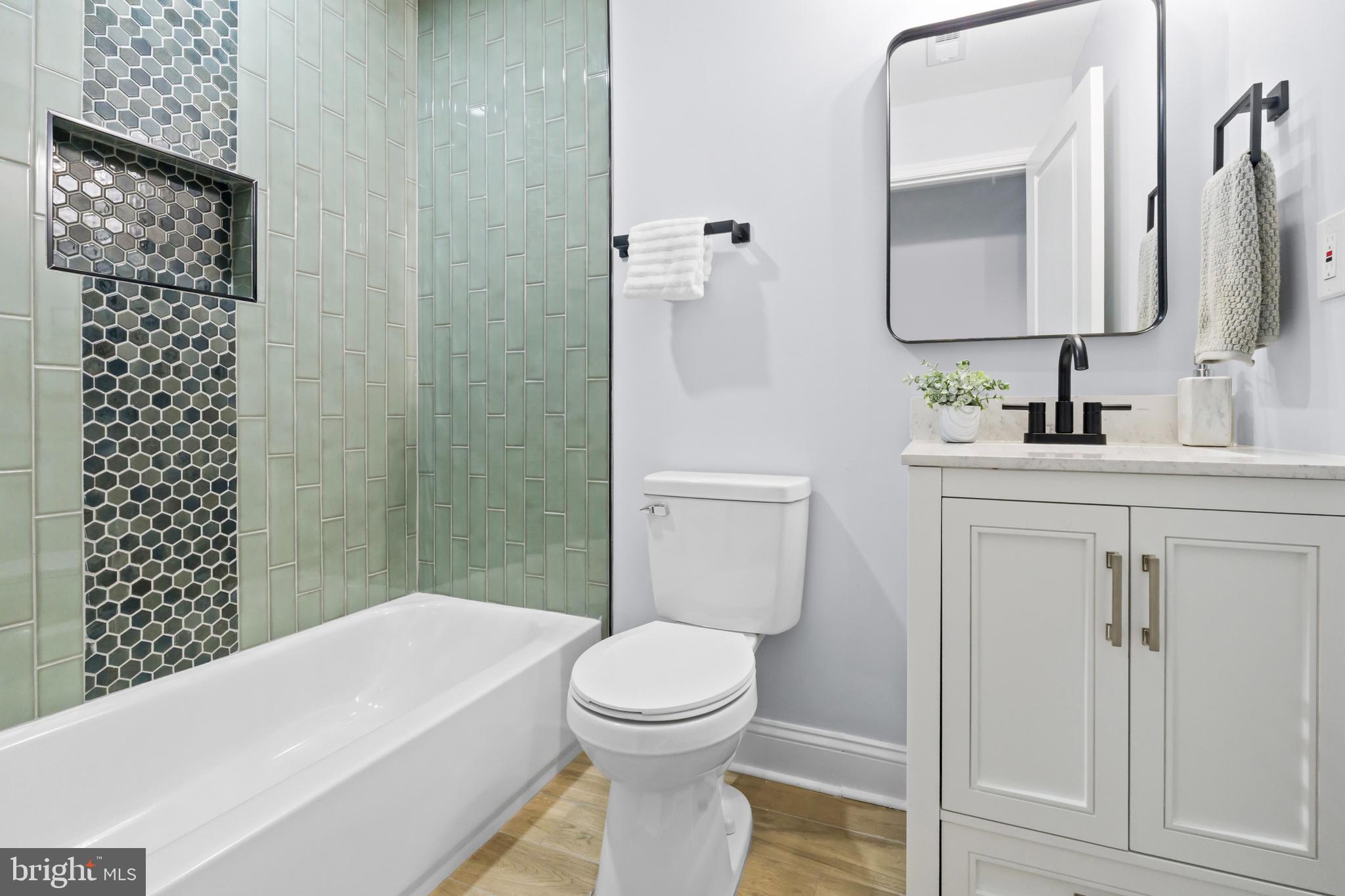 1612 East Chase Street Baltimore, MD 21213 - Photo 30 of 48 a bathroom with a sink a toilet and shower