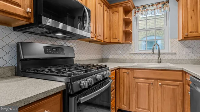 a kitchen with stainless steel appliances granite countertop a stove and a sink