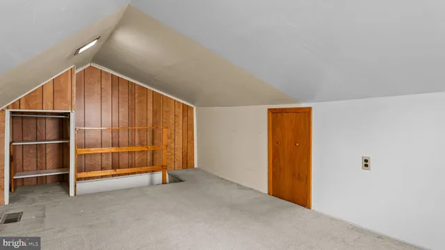 a view of an empty room with furniture and storage