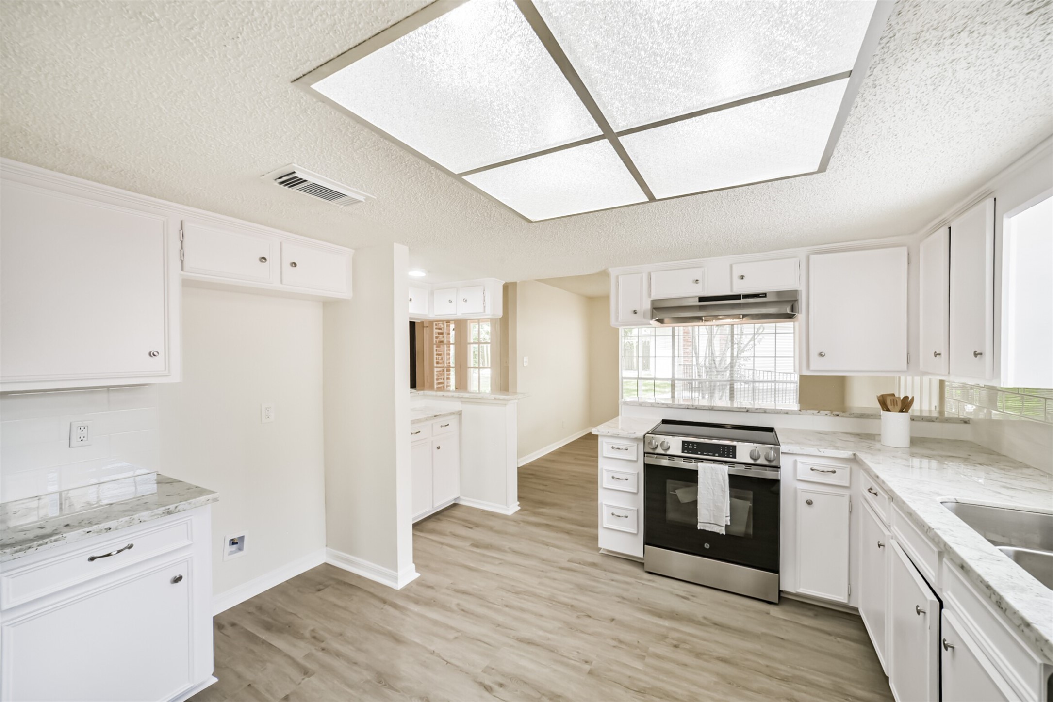 1011 Baltic Lane Houston, TX 77090 - Photo 12 of 43 a kitchen with a stove a sink and a refrigerator