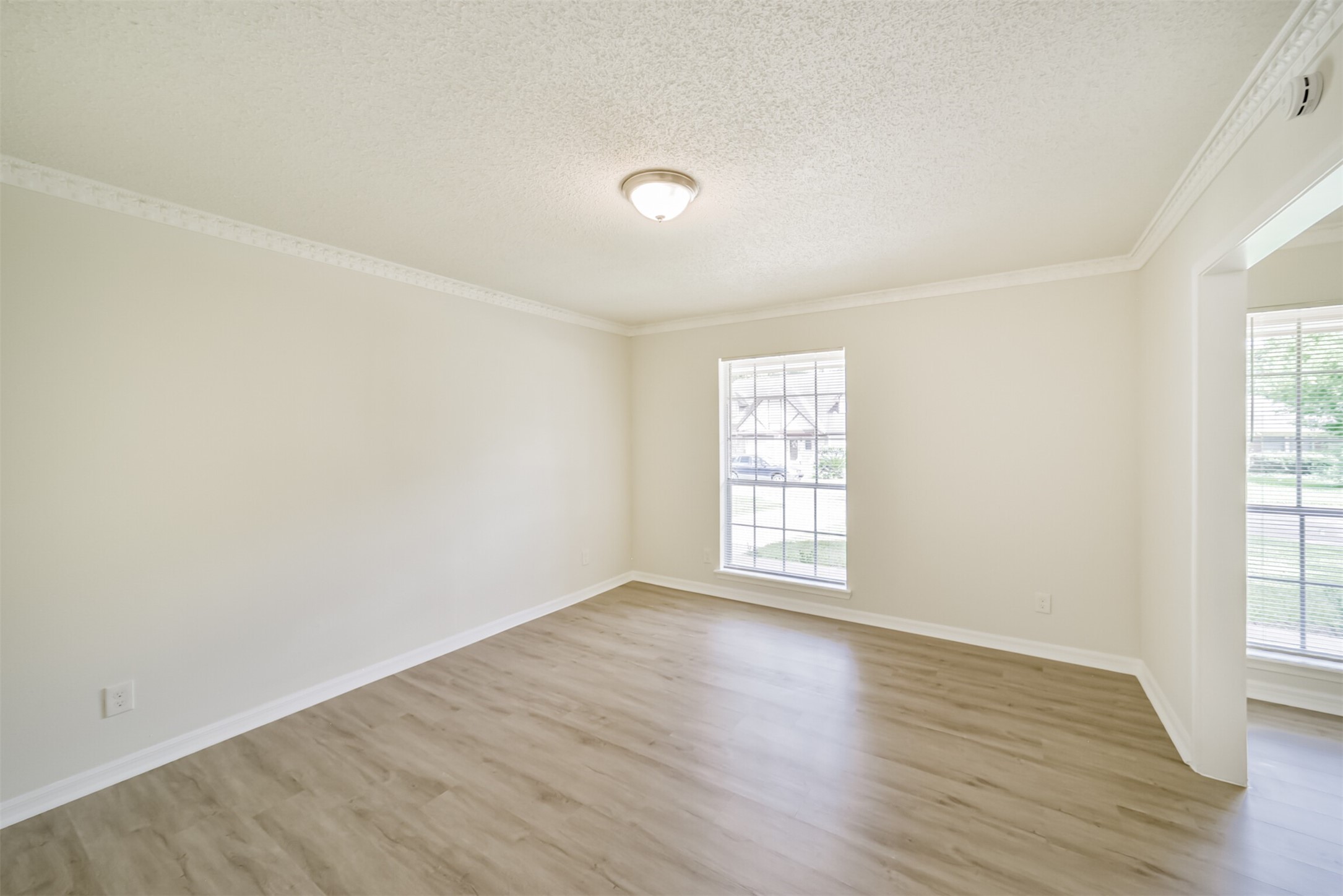 1011 Baltic Lane Houston, TX 77090 - Photo 15 of 43 an empty room with wooden floor and windows